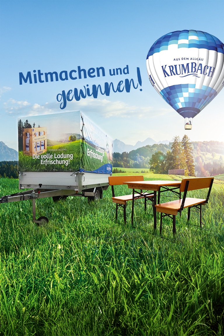 Allgäu-Landschaft mit grüner Wiese, Biertischgarnitur, Anhänger mit Krumbach-Werbung und Heißluftballon mit Schriftzug daneben „Mitmachen und gewinnen“.